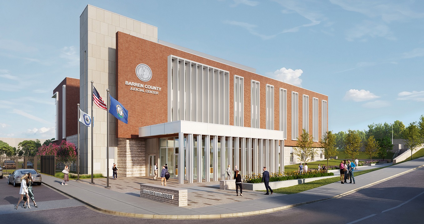   Modern brick and glass courthouse labeled ‘Barren County Judicial Center,’ with several people walking near the entrance.