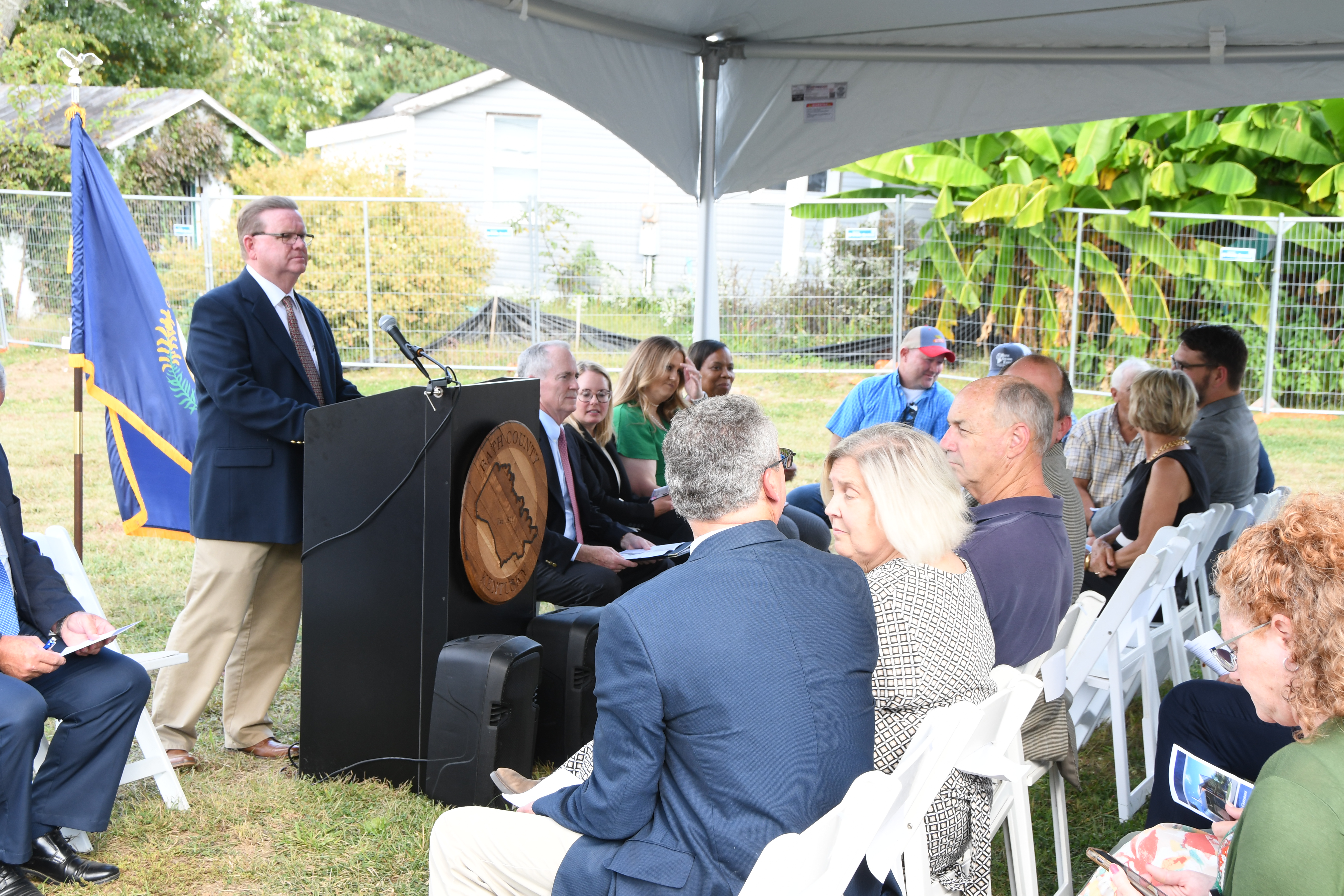 A ceremony with a man at the podium stand. 