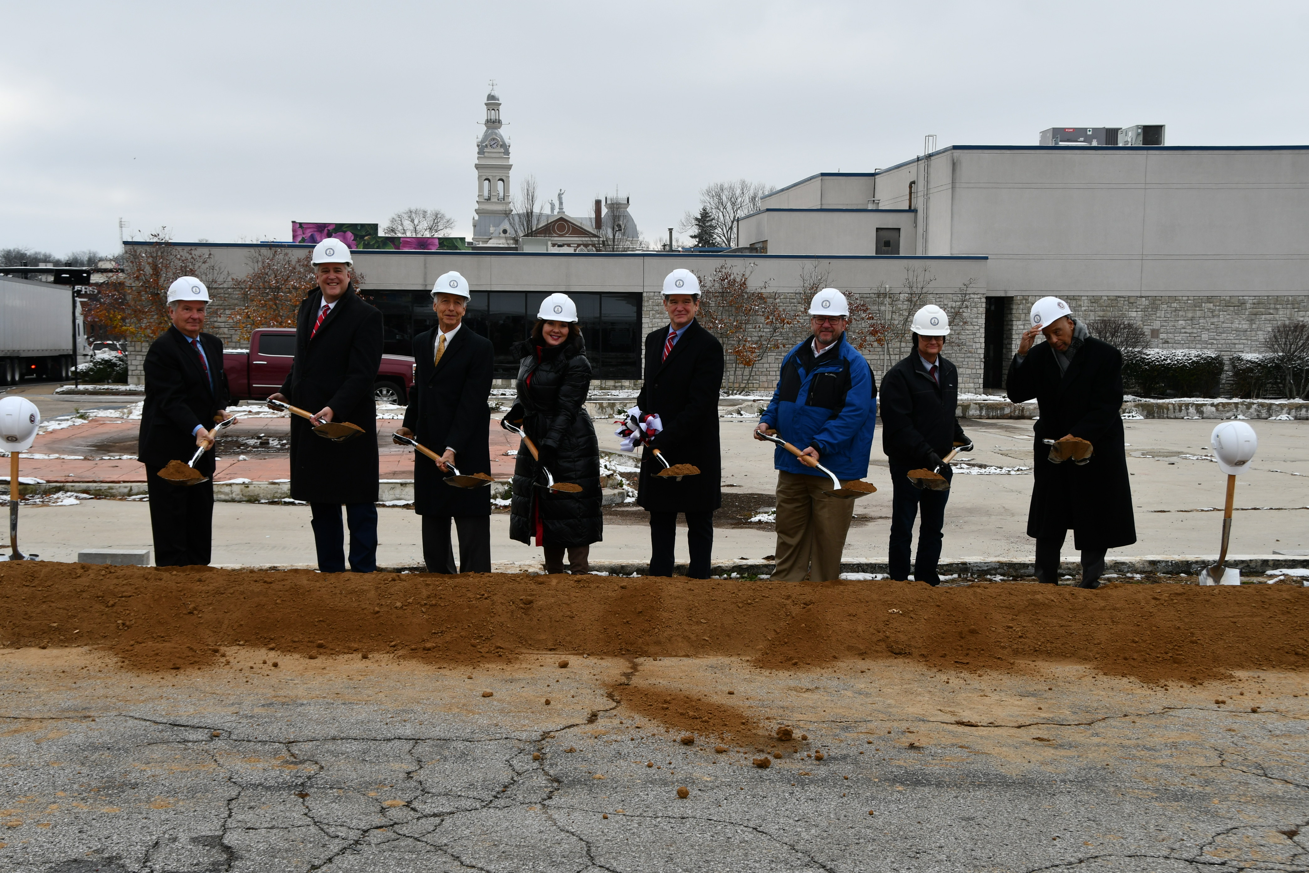 Chief Lambert and others shoveling dirt to signify the groundbreaking. 