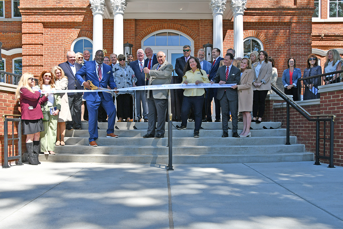 A group of individuals sharing the ribbon ceremony. 
