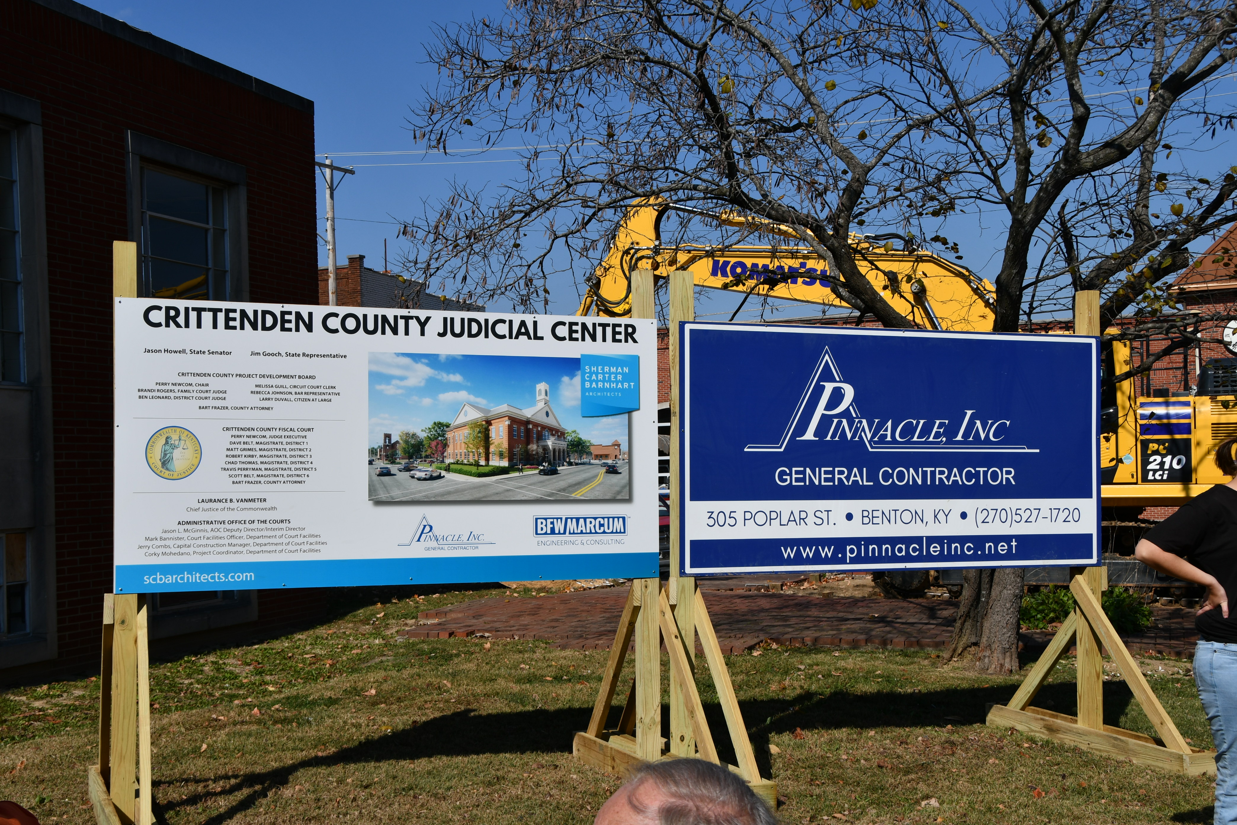 Two cardboard signs with instructions to the public about construction.
