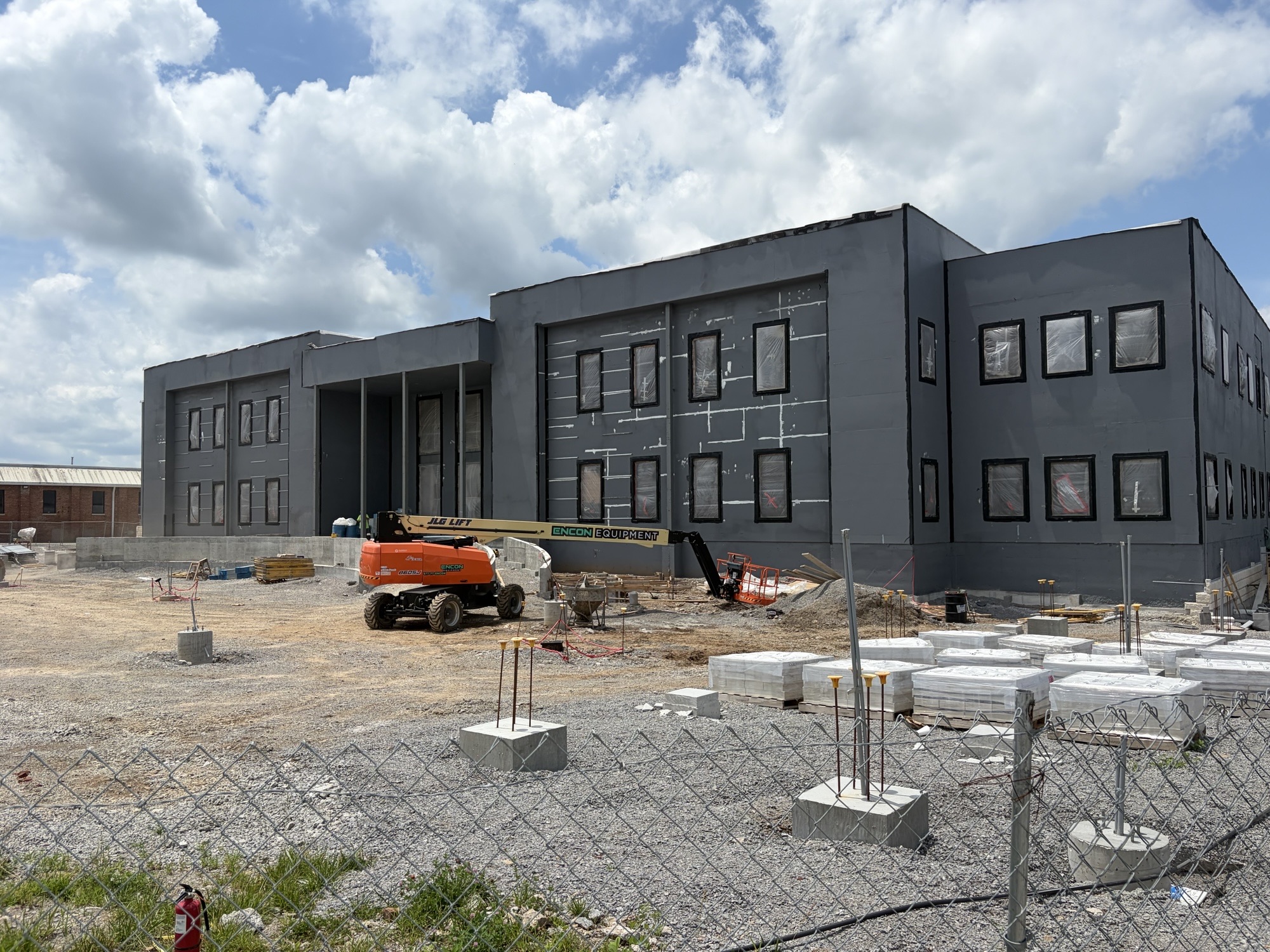 Construction site with walls up, machinery and gates. 