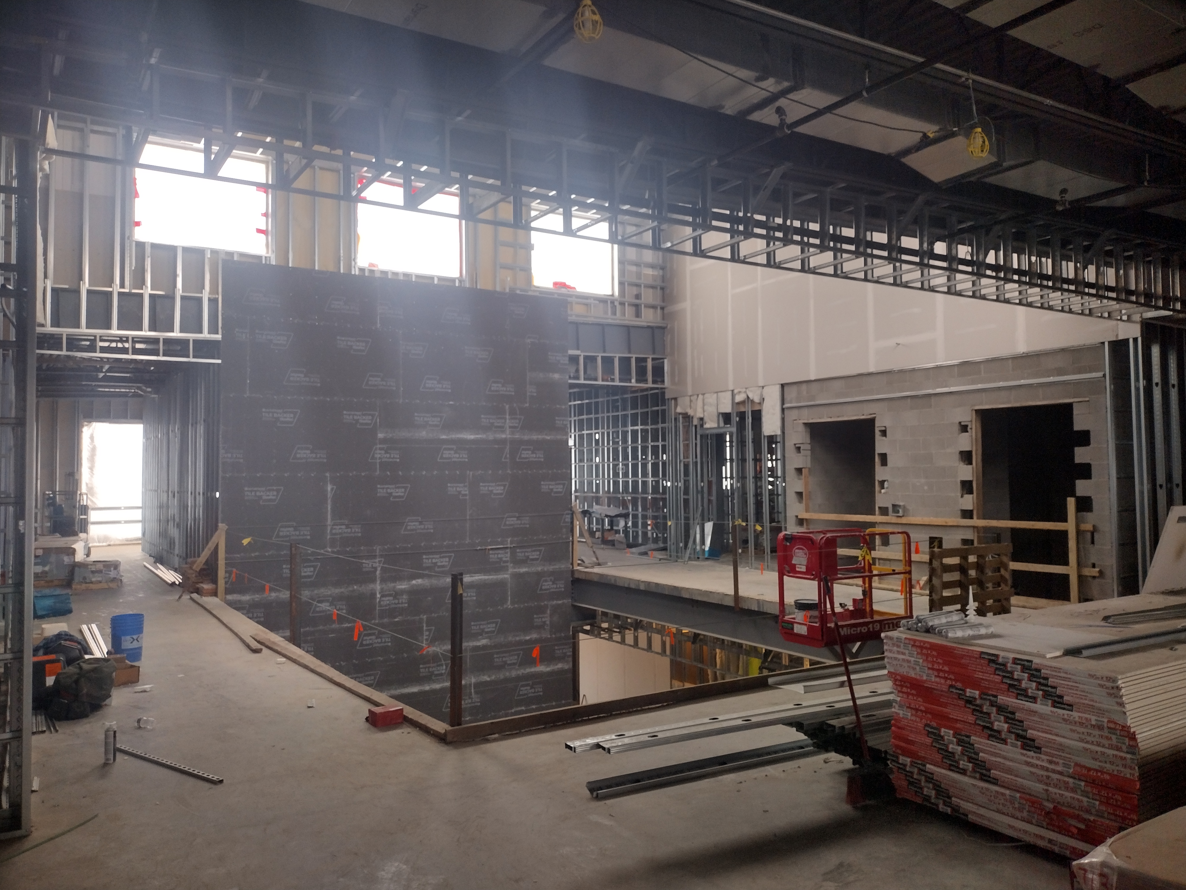 Inside the construction of the building. Tools and plywood on the floor.