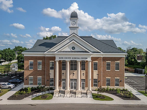 Two-story brick courthouse with large windows and a central entrance.