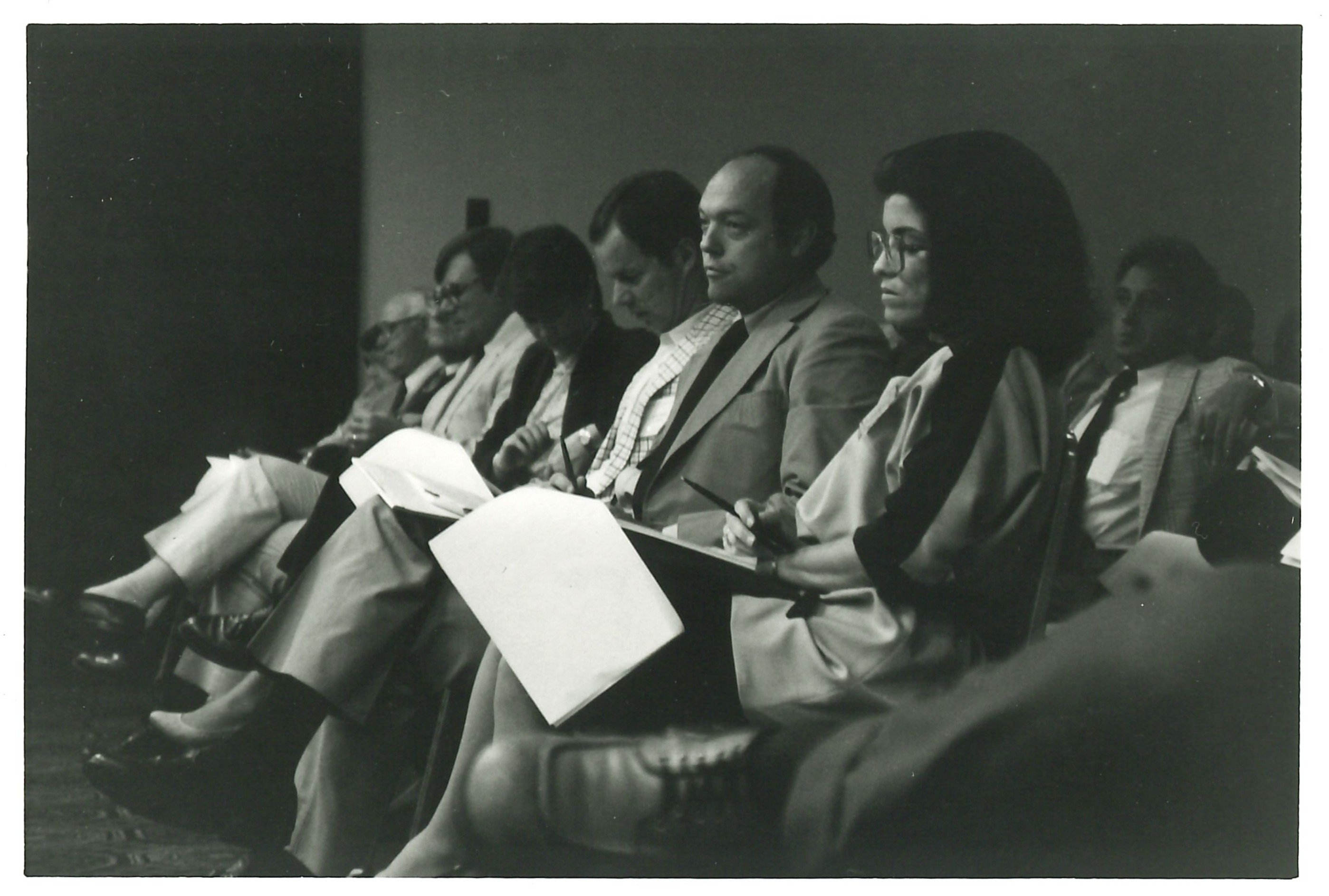 1984 Appellate Court. Individuals in the front row watching speakers as they write. 