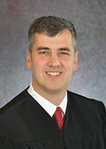 Official portrait of Judge Tyler Frazier.